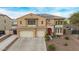 Beautiful two-story home with solar panels, red-tile roof, a three-car garage, and desert landscaping at 12910 W Tuckey Ln, Glendale, AZ 85307