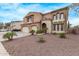 Beautiful two-story home featuring a three car garage and a red front door entrance at 12910 W Tuckey Ln, Glendale, AZ 85307