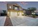 Two-story home boasts a spacious driveway, desert landscaping, and a two-car garage at 12910 W Tuckey Ln, Glendale, AZ 85307
