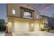 Two-story home with a two-car garage, set against a sunset sky, and desert landscaping at 12910 W Tuckey Ln, Glendale, AZ 85307