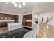Stylish kitchen featuring an island, dark wood cabinetry, and open layout to the dining at 12910 W Tuckey Ln, Glendale, AZ 85307
