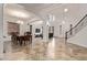 Expansive living area boasts tile floors, staircase, and seamlessly connects to dining at 12910 W Tuckey Ln, Glendale, AZ 85307