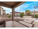 Covered patio with desert landscaping and a pergola in the distance at 12910 W Tuckey Ln, Glendale, AZ 85307
