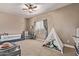 This playroom features a cozy tent filled with toys, offering endless fun and adventure at 12910 W Tuckey Ln, Glendale, AZ 85307
