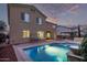 Gorgeous backyard featuring a private pool with water feature and lush greenery at 12910 W Tuckey Ln, Glendale, AZ 85307