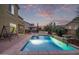 Backyard oasis with a shimmering pool, seating area, and desert plants at 12910 W Tuckey Ln, Glendale, AZ 85307
