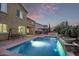 Beautiful backyard with a refreshing pool, swing, and manicured landscaping at 12910 W Tuckey Ln, Glendale, AZ 85307
