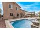 Inviting backyard pool with waterfall features, covered patio and tiled surround for relaxing summer days at 12910 W Tuckey Ln, Glendale, AZ 85307