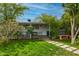 Lush backyard featuring a patio, lush greenery, a wooden bench, and a mature tree at 1326 E Almeria Rd, Phoenix, AZ 85006