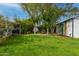 Spacious backyard with lush green grass, mature trees, stepping stones, and a cozy seating area at 1326 E Almeria Rd, Phoenix, AZ 85006