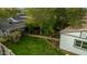 Serene backyard featuring a lush lawn, mature trees, a cozy bench, and a charming pathway, perfect for outdoor relaxation at 1326 E Almeria Rd, Phoenix, AZ 85006
