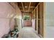 Unfinished basement area showcasing insulation, wooden framing, and a window view to the outdoors at 1326 E Almeria Rd, Phoenix, AZ 85006