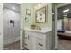 This bathroom includes a white vanity, decorative mirror, and a glass door shower with tile accents at 1326 E Almeria Rd, Phoenix, AZ 85006
