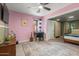 Vibrant bedroom with pink walls, desk, and a view into another connected bedroom at 1326 E Almeria Rd, Phoenix, AZ 85006