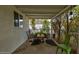 This covered patio features black metal chairs, a table, and a view of the backyard at 1326 E Almeria Rd, Phoenix, AZ 85006