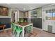Dining room featuring green chairs and a vintage rug, adjacent to laundry room at 1326 E Almeria Rd, Phoenix, AZ 85006