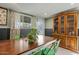 Traditional dining room is designed with dark green walls and a vintage hutch at 1326 E Almeria Rd, Phoenix, AZ 85006