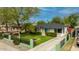 Charming home featuring a well-maintained lawn, beautiful fence, and vibrant blue door, creating a welcoming curb appeal at 1326 E Almeria Rd, Phoenix, AZ 85006