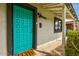 Close-up of a turquoise front door with unique square pattern design and modern hardware at 1326 E Almeria Rd, Phoenix, AZ 85006