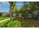 Charming front yard with a green lawn, mature trees, and a cozy seating area at 1326 E Almeria Rd, Phoenix, AZ 85006