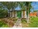 Charming backyard guest house with green double doors, surrounded by a green lawn and landscaping at 1326 E Almeria Rd, Phoenix, AZ 85006