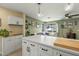 Bright kitchen boasts white cabinetry, quartz counters, and a view into the living area at 1326 E Almeria Rd, Phoenix, AZ 85006