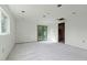 An unfinished living room featuring new tile flooring, windows, and green french doors at 1326 E Almeria Rd, Phoenix, AZ 85006