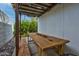 Cozy covered patio with rustic wooden furniture, an outdoor dining space, and a heater at 1326 E Almeria Rd, Phoenix, AZ 85006