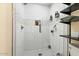 The shower features a glass door, tiled walls and floor, and built-in shelving for toiletries at 1326 E Almeria Rd, Phoenix, AZ 85006