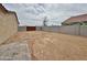 Large dirt backyard with block wall, pavers, and a gate at 15422 S Sequoia Cir, Arizona City, AZ 85123