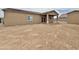 Wide view of the dirt backyard and covered patio at 15422 S Sequoia Cir, Arizona City, AZ 85123
