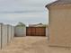View of the backyard gate and stucco wall at 15422 S Sequoia Cir, Arizona City, AZ 85123