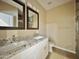 Modern bathroom with dual sinks, granite countertops, and a tiled shower at 15422 S Sequoia Cir, Arizona City, AZ 85123