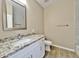 Well-lit bathroom features granite counters, white cabinetry, and a tiled shower at 15422 S Sequoia Cir, Arizona City, AZ 85123