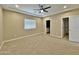 A modern bedroom offers a neutral color palette and an attached bathroom at 15422 S Sequoia Cir, Arizona City, AZ 85123