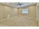 Spacious carpeted bedroom with modern ceiling fan and a neutral color palette at 15422 S Sequoia Cir, Arizona City, AZ 85123