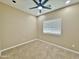 Bright bedroom features neutral carpet, window, ceiling fan, and a baseboard at 15422 S Sequoia Cir, Arizona City, AZ 85123