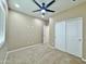 Carpeted bedroom with a ceiling fan, window, closet and a doorway for easy access at 15422 S Sequoia Cir, Arizona City, AZ 85123