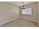 Bright dining room features wood-look tile flooring and modern light fixture at 15422 S Sequoia Cir, Arizona City, AZ 85123