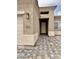 Inviting entryway features paver walkway, stucco walls, and stylish outdoor lighting at 15422 S Sequoia Cir, Arizona City, AZ 85123