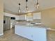 Modern kitchen island with granite countertops and stylish pendant lighting with stainless steel appliances at 15422 S Sequoia Cir, Arizona City, AZ 85123