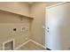 Laundry room with a shelf, hookups for appliances, and easy access to the backyard at 15422 S Sequoia Cir, Arizona City, AZ 85123
