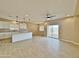 Bright, open-concept living area with stylish light fixtures and access to outdoor patio at 15422 S Sequoia Cir, Arizona City, AZ 85123