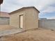 View of the stucco backyard shed with concrete tile roof at 15422 S Sequoia Cir, Arizona City, AZ 85123