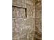 Shower stall clad with stone-look tile and featuring an integrated storage niche at 15422 S Sequoia Cir, Arizona City, AZ 85123