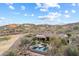 Breathtaking aerial view of a luxury home with a pool, spa, patio, and lush landscaping in a scenic desert community at 15956 E Tombstone Trl, Fountain Hills, AZ 85268