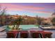 Backyard showcasing a luxurious pool, spa, sun loungers, and desert landscaping with scenic views at 15956 E Tombstone Trl, Fountain Hills, AZ 85268