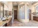 Bright bathroom boasts dual vanities, tiled flooring, and a unique glass block shower enclosure at 15956 E Tombstone Trl, Fountain Hills, AZ 85268