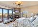 Bedroom with stone fireplace and glass doors opening to the back patio at 15956 E Tombstone Trl, Fountain Hills, AZ 85268
