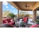 Inviting covered patio with comfortable seating, ceiling fans and desert views creating a relaxing outdoor living space at 15956 E Tombstone Trl, Fountain Hills, AZ 85268